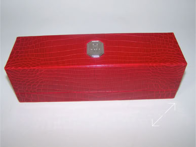 A red crocodile rectangular bracelet box with a real leather surface and a platinum hexagonal metal Harry Winston plate on the top by Swiss Packaging.
